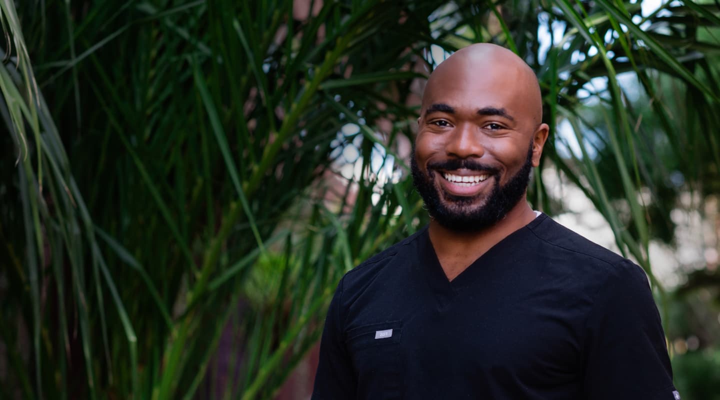 Photo of Justin, one of our staff members, standing outside smiling.